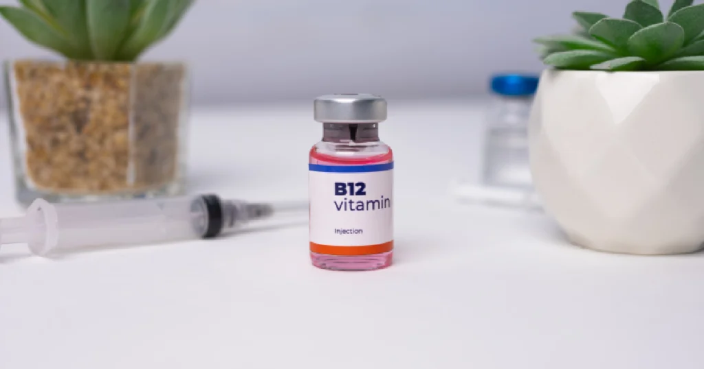 Lipo B12 injection vial with syringe and succulents on a white surface in Commerce, GA